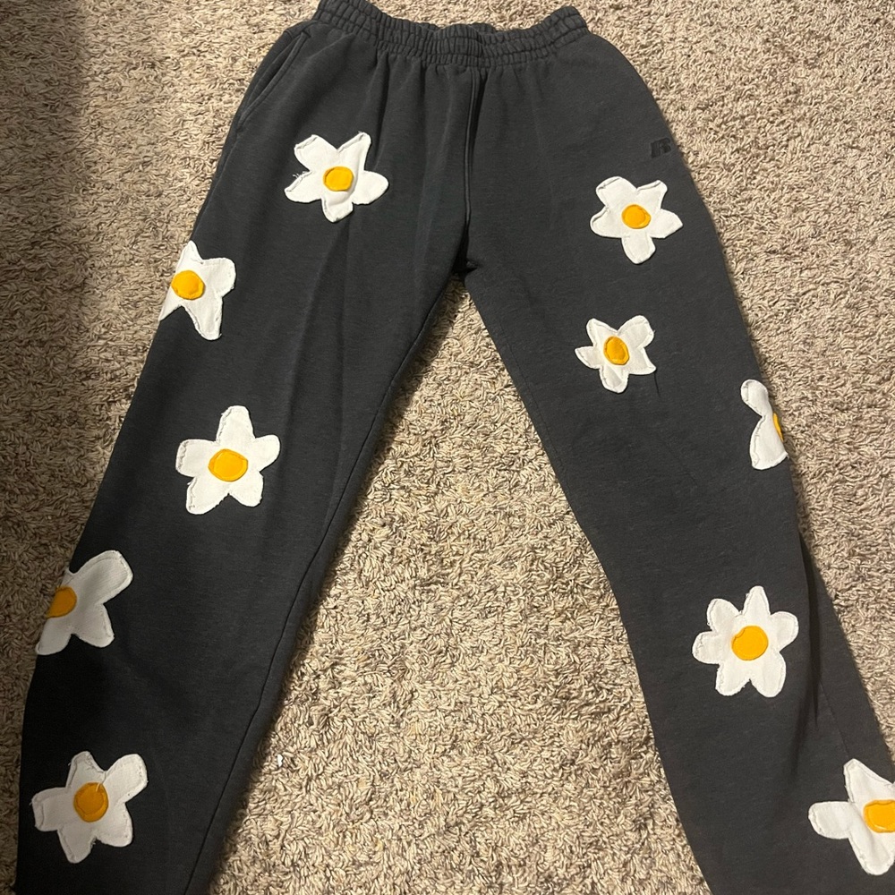 Dark grey sweatpants with flowers on them